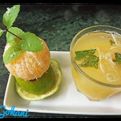 A picture of Ganga Jamuna juice with mint ice cubes.