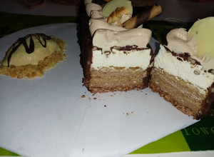 Una foto de Tarta con mousseline de chocolate y ganache acompañada de helado