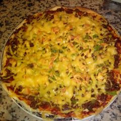 A picture of Homemade pizza with minced beef and cheese topping.