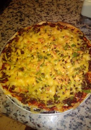 A picture of Homemade pizza with minced beef and cheese topping.