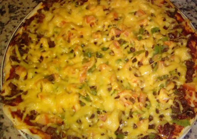 Homemade pizza with minced beef and cheese topping