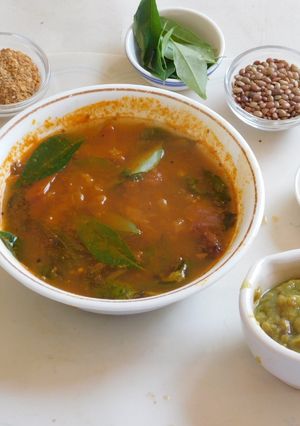 A picture of AROMATIC SPICY FLAVORFUL HEALTHY RASAM /SOUP WITH HORSE GRAM AND TOMATOES.