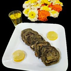A picture of Boiled colocasia leaves with moong dal and chawli dal.