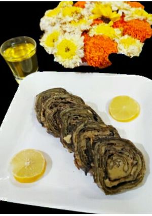 A picture of Boiled colocasia leaves with moong dal and chawli dal.