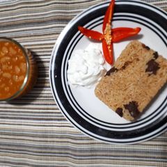 A picture of Pilau served with beans.
