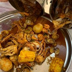 A picture of Seafood boil w/red n hot sauce.