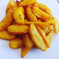 A picture of Baked turmeric potato wedges.