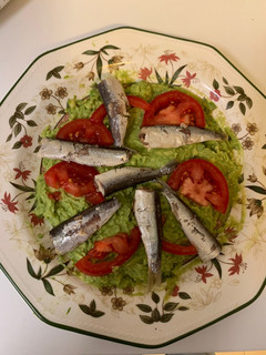 Una foto de Sardinillas en conserva sobre ensalada de aguacate con limón, sal y tomate