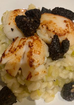 A picture of Simple risotto base topped with scallops and black pudding.