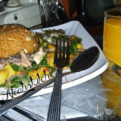 A picture of Party jollof rice with sweetpotatoes and spinach sauce.