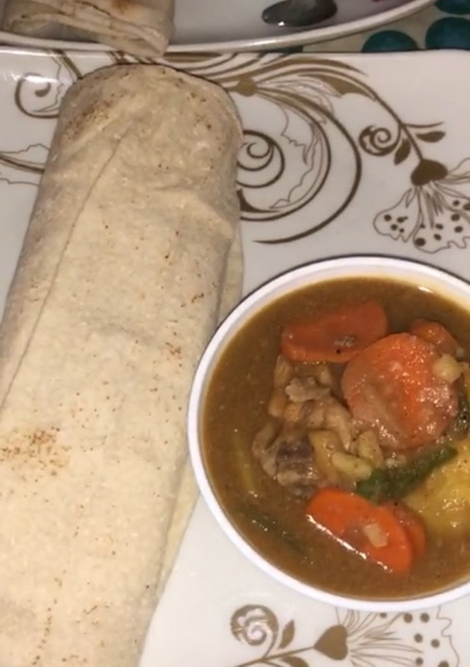 A picture of Chicken soup with bread.