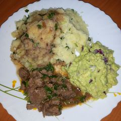 A picture of Mashed potatoes served with beef.