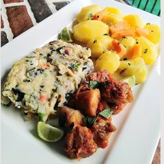 A picture of Fried egg with chicken and potatoes.