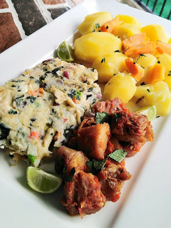 A picture of Fried egg with chicken and potatoes.