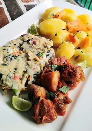 A picture of Fried egg with chicken and potatoes.