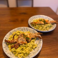 Pasta with avocado sauce served with fried soft shell crab A picture of Pasta with avocado sauce served with fried soft shell crab.