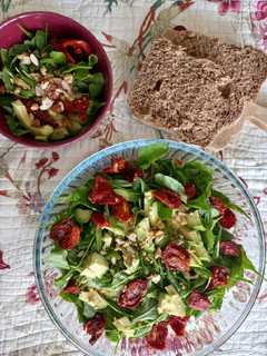 Una foto de Ensalada de rúcula, tomates secos, palta y frutos secos