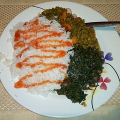 A picture of Boiled Rice Green grams stew and fried sukuma wiki.