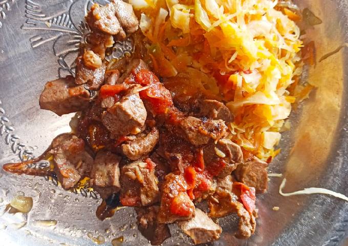 Simple steamed cabbages alongside fried liver