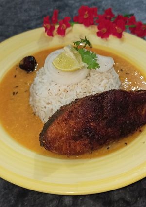 A picture of Daal Chawal with fry Fish.