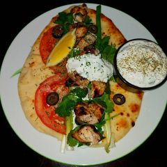 A picture of Mike's Grilled Chicken On Naan With Tzatziki Sauce.