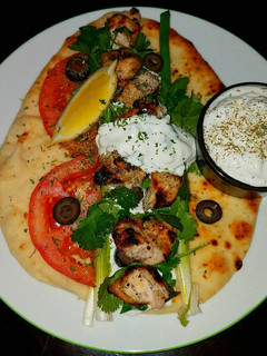 A picture of Mike's Grilled Chicken On Naan With Tzatziki Sauce.