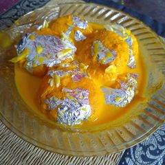 A picture of Orange rasmalai.