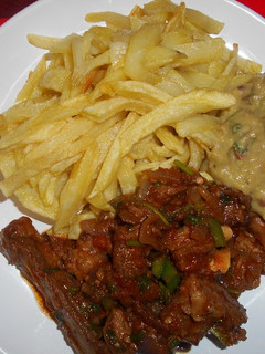 A picture of French fries, fried mutton & guacamole.