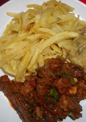 A picture of French fries, fried mutton & guacamole.