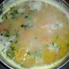 A picture of Red lentil  with chopped coriander leaves.