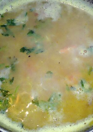 A picture of Red lentil  with chopped coriander leaves.