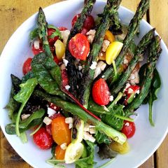 A picture of Grilled asparagus, tomato and feta salad.
