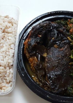 A picture of Ofada rice with vegetable sauce and dry fish.