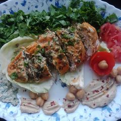 Creamy Spinach Cheese Stuffed Chicken Served With Hummus A picture of Creamy Spinach Cheese Stuffed Chicken Served With Hummus.