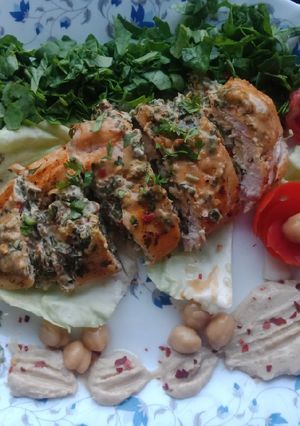 A picture of Creamy Spinach Cheese Stuffed Chicken Served With Hummus.