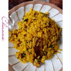A picture of Local Jellof Rice With Palm Oil, Scent leaf and Dry Fish.