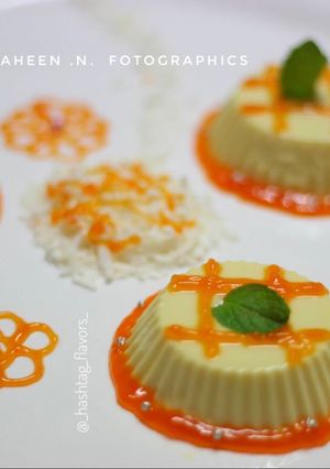 A picture of Vanilla-Coconut PannaCotta with orange reduction sauce.