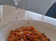 Una foto de arroz con mariscos y tomate