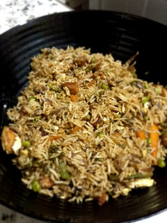 A picture of Vegetable and chicken fried rice.
