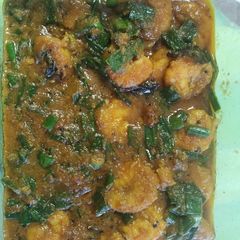 A picture of Prawn curry with spring onion.