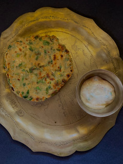 A picture of Methi Aloo Paratha & Spring Onion Raita.
