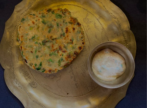A picture of Methi Aloo Paratha & Spring Onion Raita.