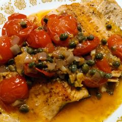 A picture of Steelhead trout with spicy tomato and caper sauce.