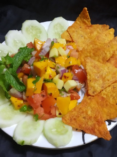 A picture of Mango salsa with nachoes.