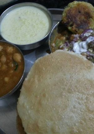 A picture of Chole bhature, ALOO Tikki, kheer.