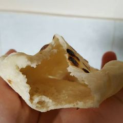 A picture of Pita bread on the pan with sourdough starter.