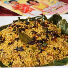 Vazhayilayil Oru Suriyani Biriyani / Kerala Suriyanese Style Biryani Wrapped in Banana Leaf A picture of Vazhayilayil Oru Suriyani Biriyani / Kerala Suriyanese Style Biryani Wrapped in Banana Leaf.