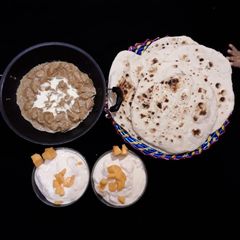 A picture of Boneless chicken Handi homemade Naan.