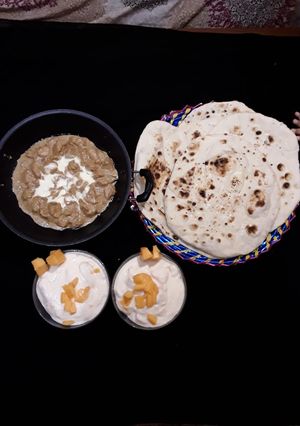 A picture of Boneless chicken Handi homemade Naan.