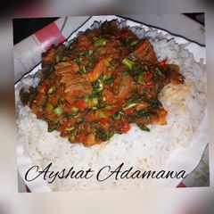 A picture of White rice with spinach sauce.